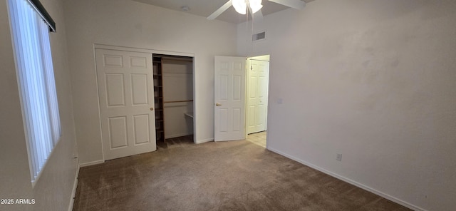 unfurnished bedroom featuring baseboards, a closet, visible vents, and light colored carpet