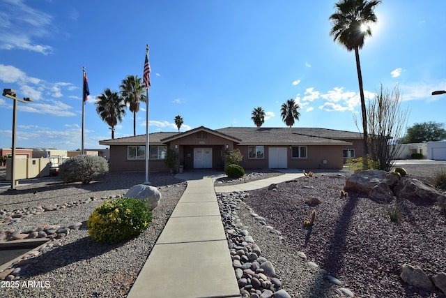 single story home featuring fence and stucco siding