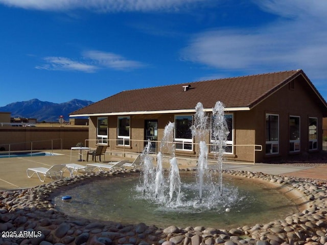 view of home's community with fence and a mountain view