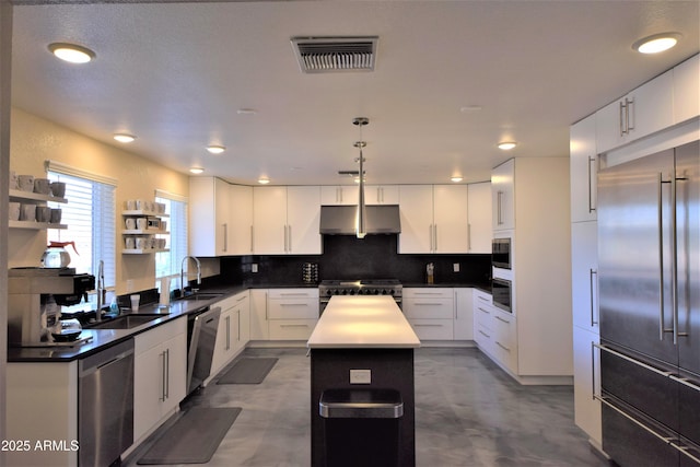 kitchen with under cabinet range hood, visible vents, a center island, open shelves, and high end appliances