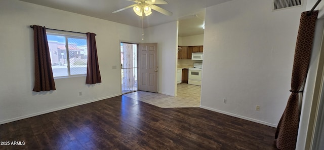 empty room with light wood-style floors, visible vents, baseboards, and a ceiling fan