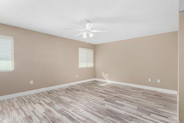 unfurnished room featuring baseboards, a ceiling fan, and light wood finished floors