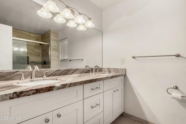 bathroom with a sink, double vanity, and a shower stall