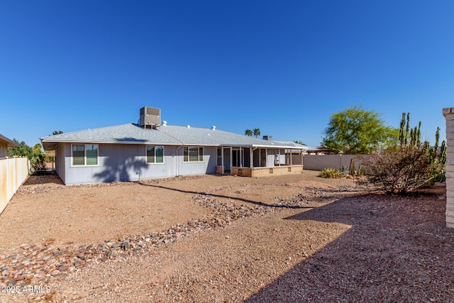 rear view of property with cooling unit, a fenced backyard, and a sunroom