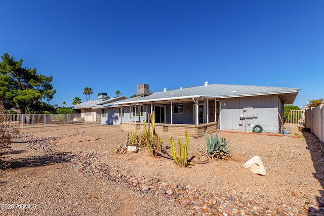 rear view of property featuring cooling unit and a fenced backyard