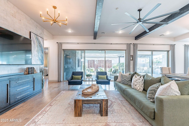 living room featuring light wood-style floors, beam ceiling, visible vents, and plenty of natural light