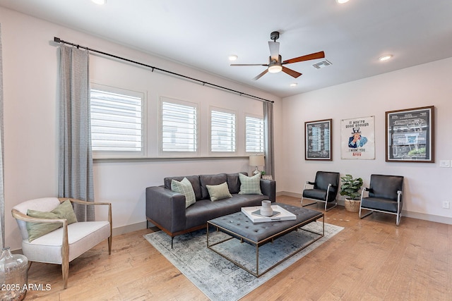 living room featuring baseboards and light wood finished floors