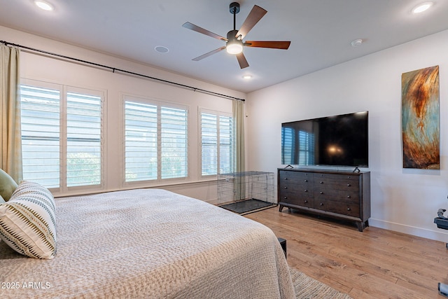 bedroom with light wood finished floors, multiple windows, recessed lighting, and baseboards