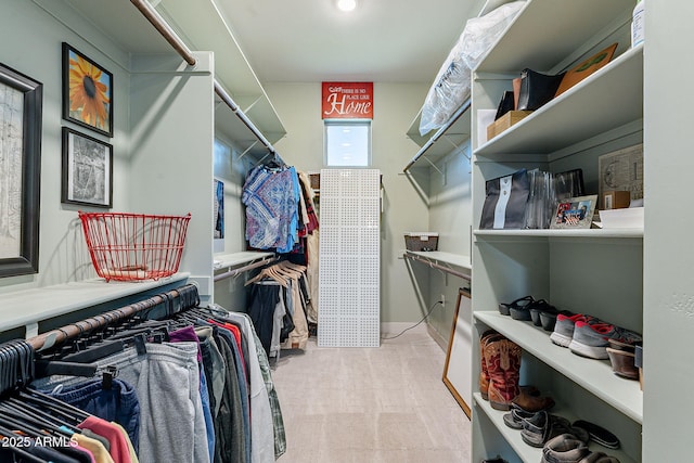 spacious closet featuring light colored carpet