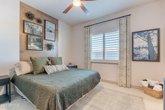 carpeted bedroom featuring a ceiling fan and baseboards