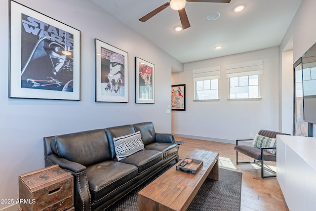 living room featuring baseboards, light wood finished floors, a ceiling fan, and recessed lighting