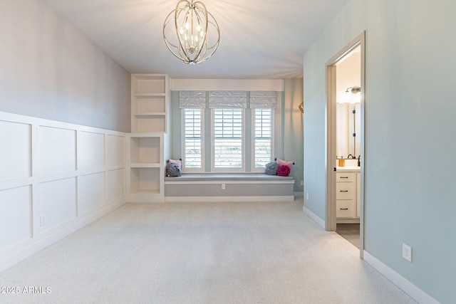 interior space featuring a chandelier and a decorative wall