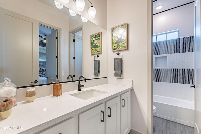 full bath featuring vanity and toilet