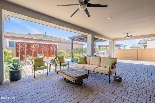 view of patio featuring a ceiling fan, outdoor dining space, fence, and an outdoor living space