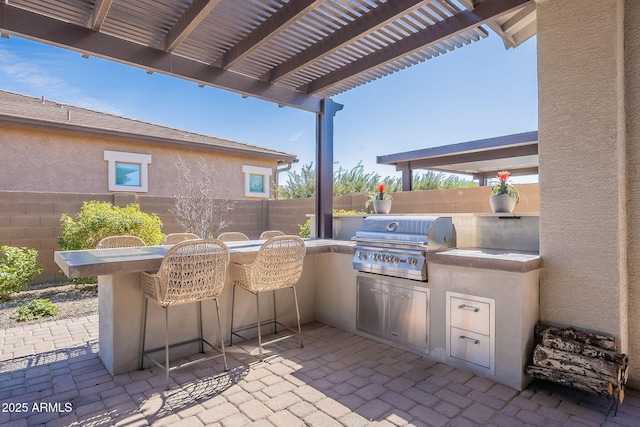 view of patio / terrace with fence, a pergola, and area for grilling