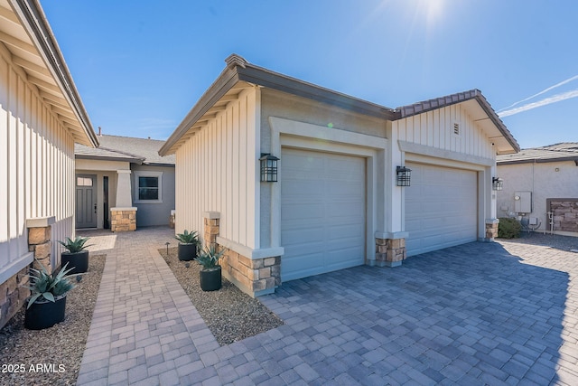 garage with decorative driveway