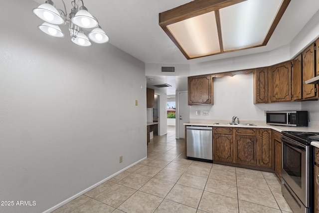 2064 S Farnsworth Dr Unit 43, Mesa, AZ 85209 - kitchen with stainless steel appliances, light countertops, light tile patterned floors, and a chandelier