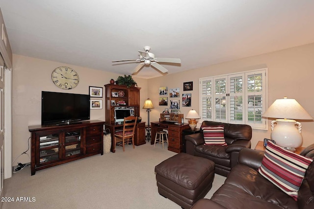 carpeted living room with ceiling fan