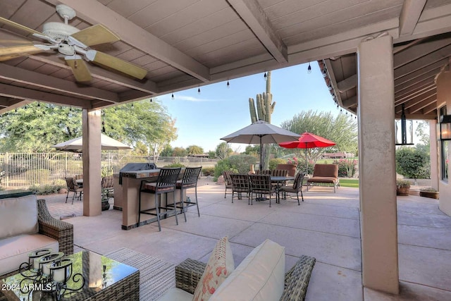 view of patio / terrace featuring ceiling fan and a bar