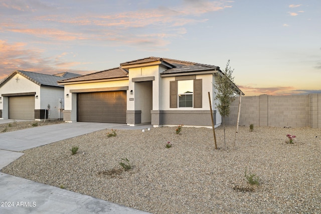 24066 W Cocopah St, Buckeye, AZ 85326 - view of front of property with fence, stucco siding, a garage, and a tile roof