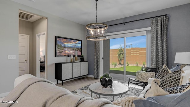 24066 W Cocopah St, Buckeye, AZ 85326 - living room with wood finished floors, a chandelier, and baseboards