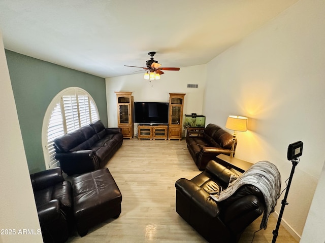 living room featuring ceiling fan and light hardwood / wood-style floors