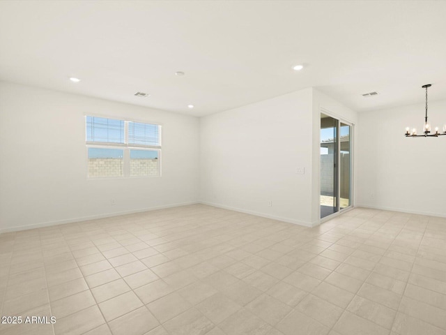 unfurnished room featuring an inviting chandelier