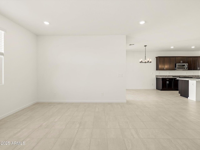 unfurnished living room with a notable chandelier