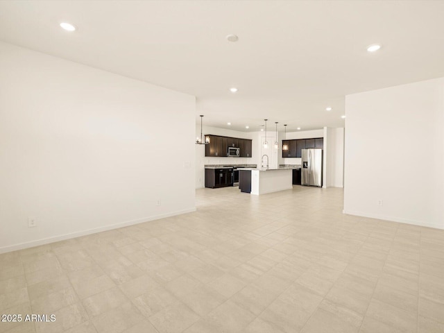 unfurnished living room with sink