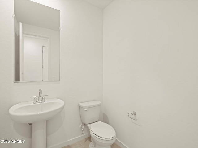 bathroom featuring toilet and tile patterned flooring