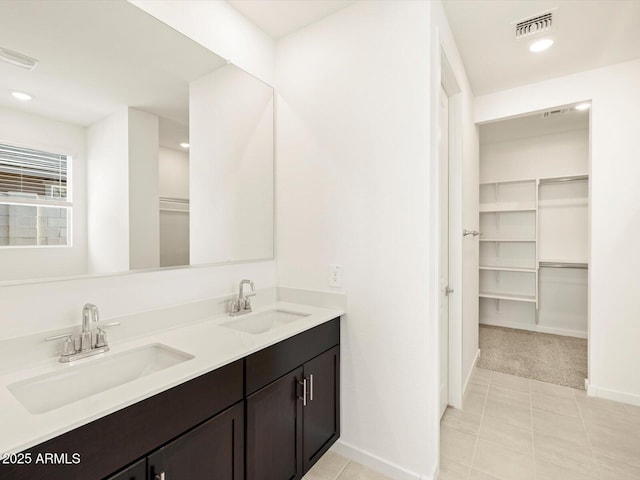 bathroom with tile patterned flooring and vanity