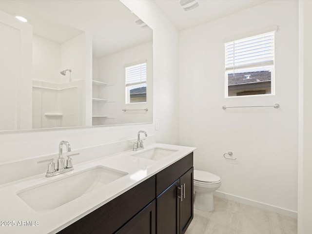 bathroom featuring toilet, a shower, tile patterned floors, and vanity