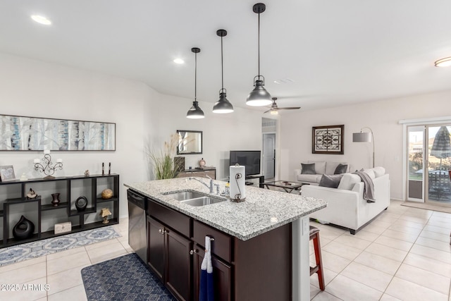 kitchen with decorative light fixtures, light stone countertops, dishwasher, and sink