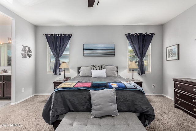 bedroom featuring sink, ensuite bathroom, ceiling fan, and light colored carpet