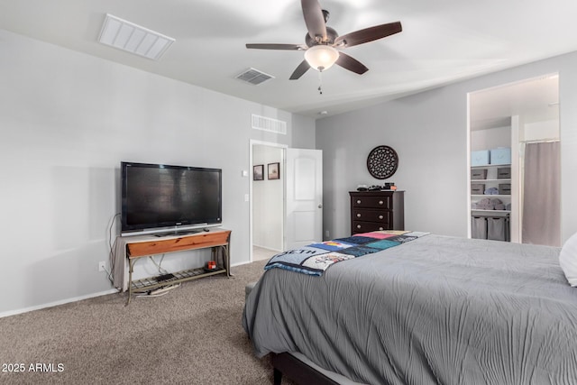 bedroom with ensuite bathroom, ceiling fan, and carpet flooring