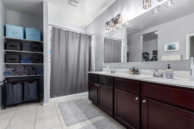 bathroom featuring walk in shower, tile patterned flooring, and vanity