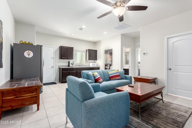 living room featuring ceiling fan and light tile patterned floors