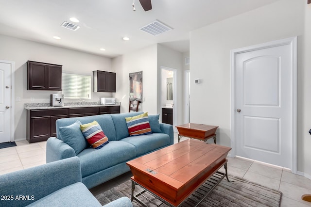 living room with ceiling fan, light tile patterned flooring, and sink