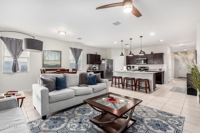 living room featuring ceiling fan and light tile patterned floors