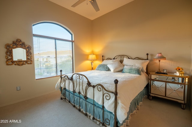 bedroom with baseboards, a ceiling fan, vaulted ceiling, and carpet flooring