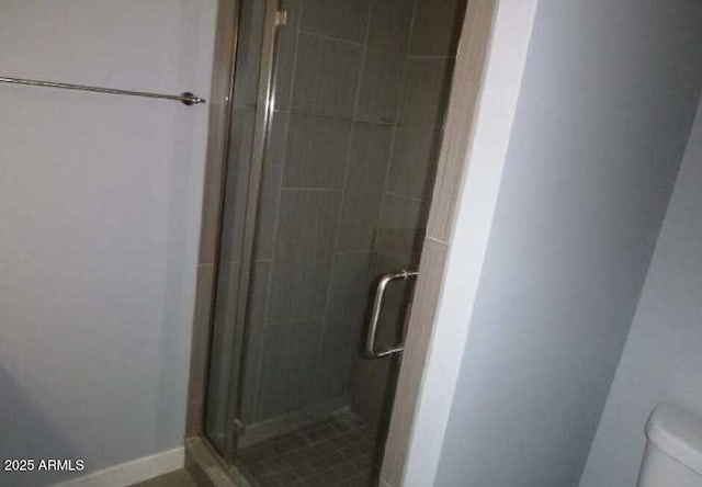 full bathroom with toilet and a shower stall