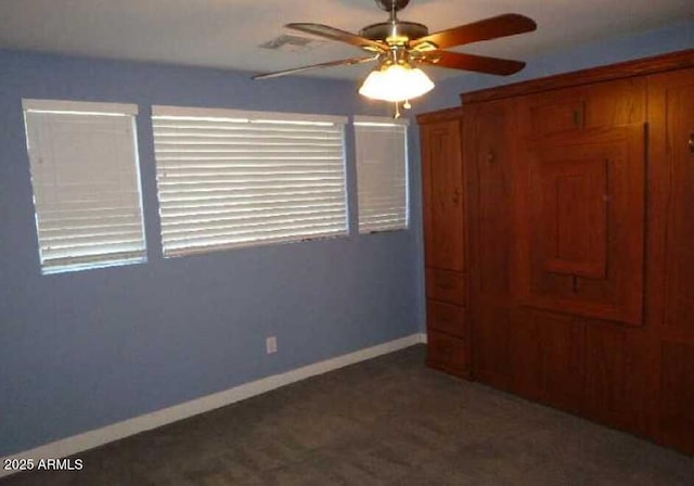 unfurnished bedroom featuring ceiling fan and baseboards