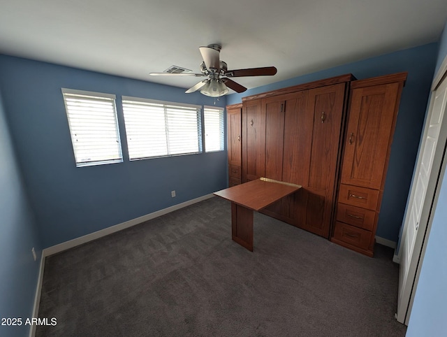 unfurnished bedroom featuring dark carpet, baseboards, and ceiling fan