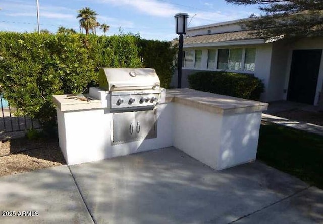 view of patio with an outdoor kitchen and area for grilling