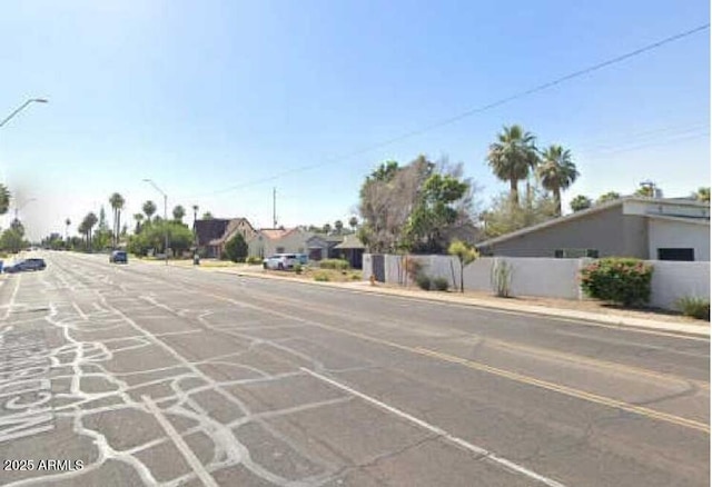 view of street featuring curbs, street lighting, and sidewalks