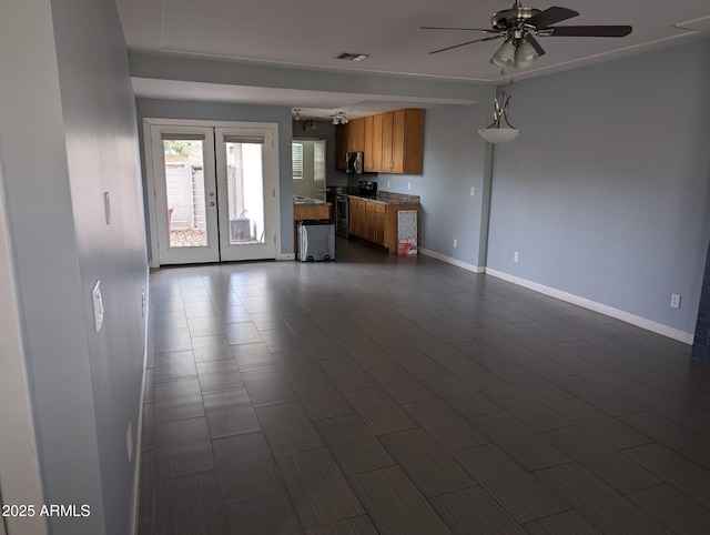 unfurnished living room with french doors, visible vents, ceiling fan, and baseboards