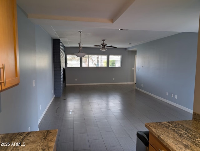 empty room with visible vents, baseboards, and a ceiling fan