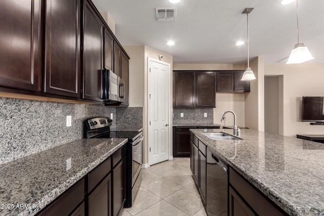 kitchen with dark stone counters, black appliances, a sink, and visible vents