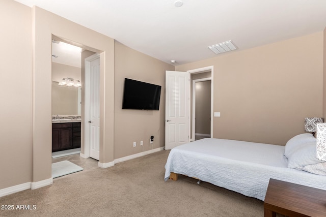 bedroom featuring baseboards, ensuite bath, visible vents, and light colored carpet