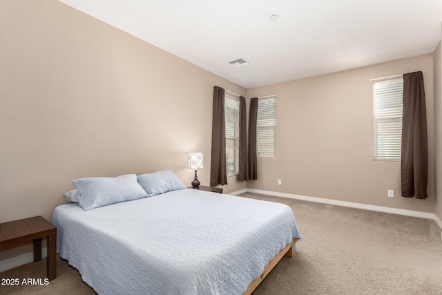 carpeted bedroom with baseboards and visible vents